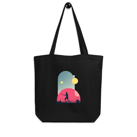 Tote-bag Smash Chromatique en coton bio noir avec illustration colorée d’un joueur de tennis en action, mélange de rose vif, bleu et jaune lumineux, style graphique dynamique, sur fond évoquant un court en plein air.